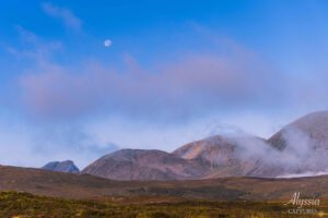 Early morning in Scotland with moon over the mountains.