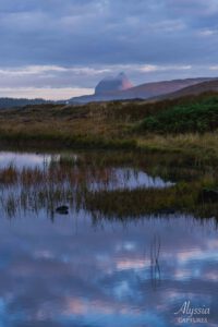 Foggy sunrise over lake and mountain in Scottland.