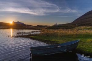 Sunset over lake and boat in Scottland.